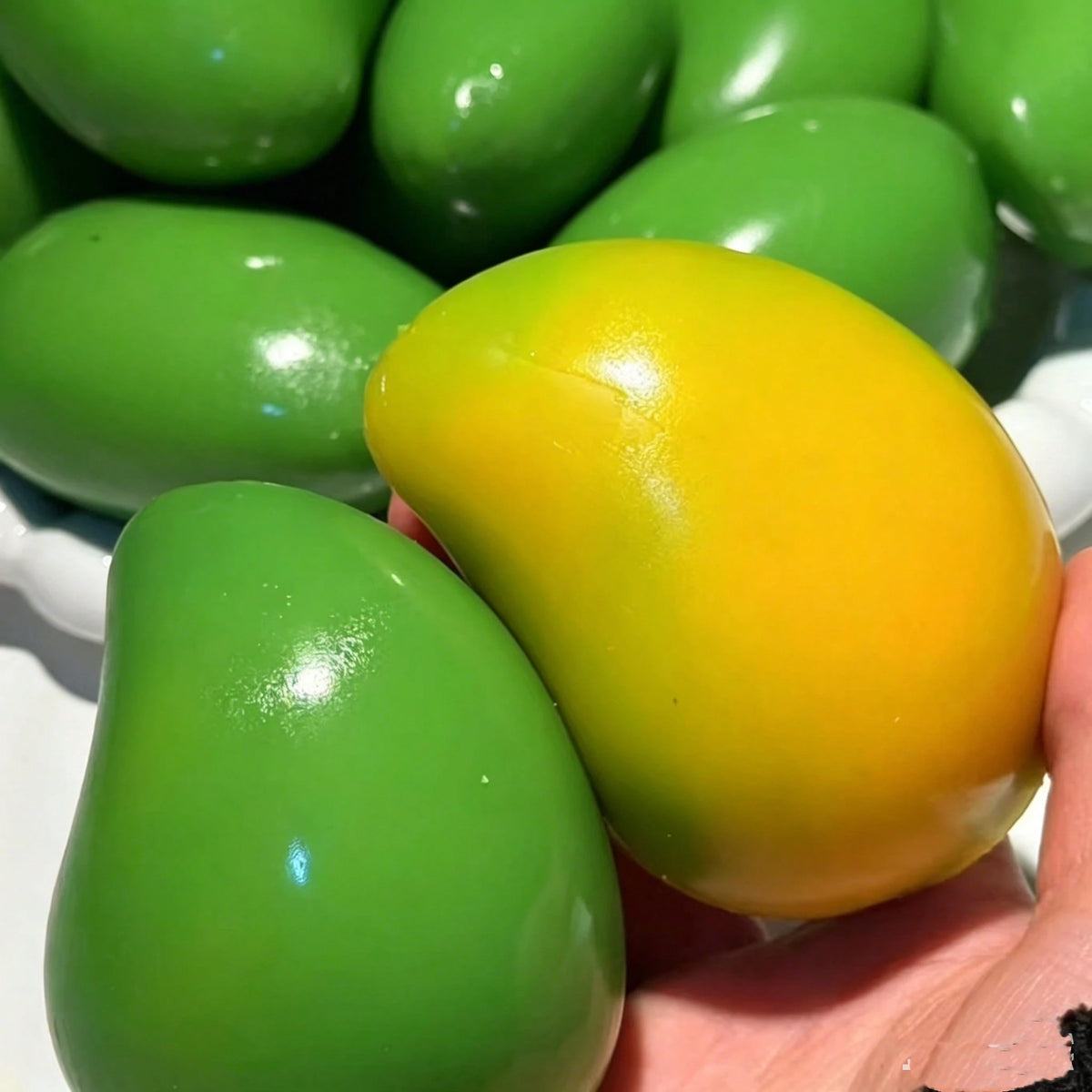 Mango squishy in hand