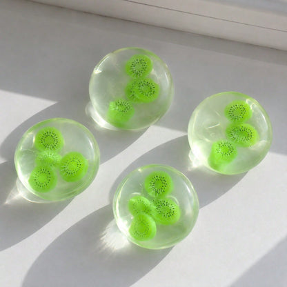 Fruit squeeze ball being pressed