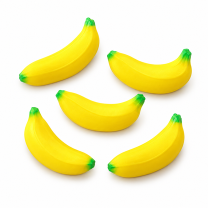Five miniature yellow banana stress toys on a white background