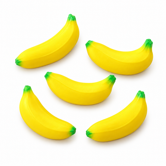 Five miniature yellow banana stress toys on a white background