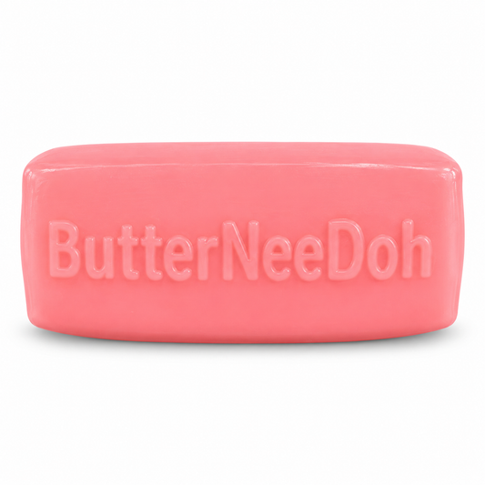 Single pink Strawberry Butter squishy with embossed ButterNeeDoh lettering on a white background